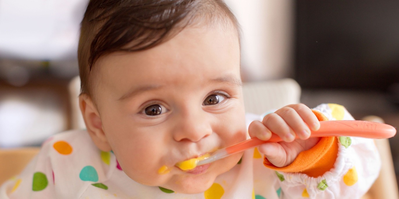 Baby eating with a spoon