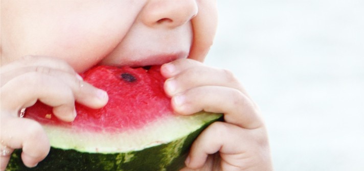 Baby eating watermelon