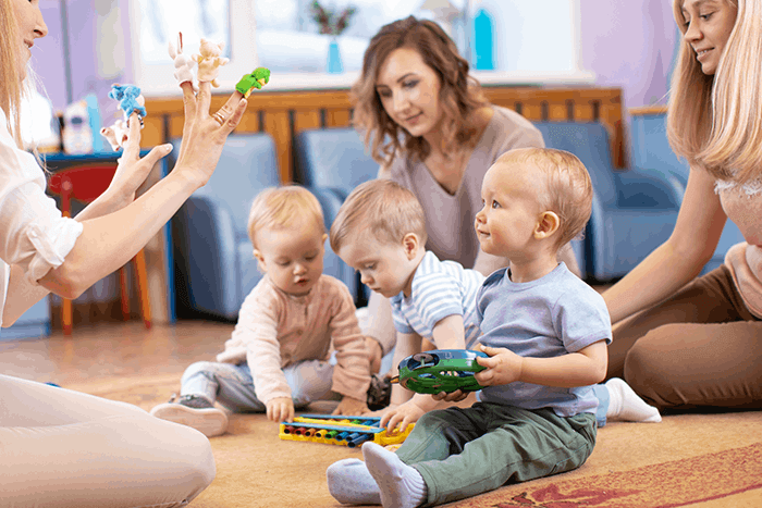 children in nursery under the care of educators