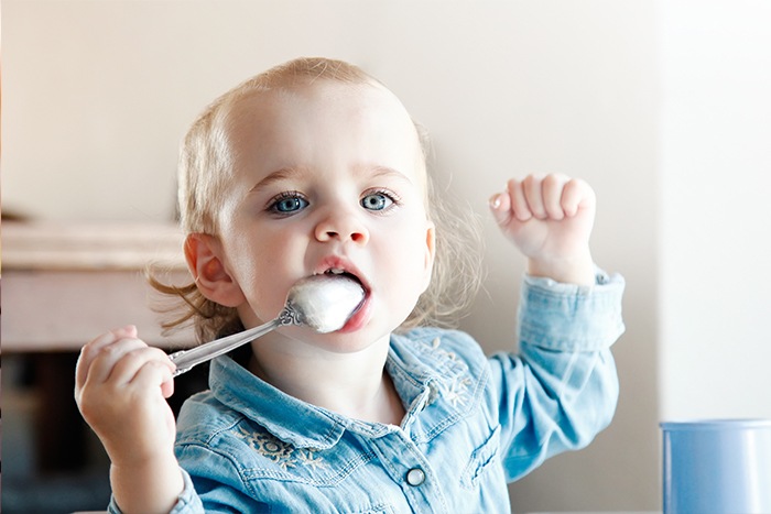 baby with a teaspoon