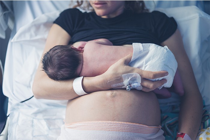 Woman breastfeeding newborn baby at the hospital