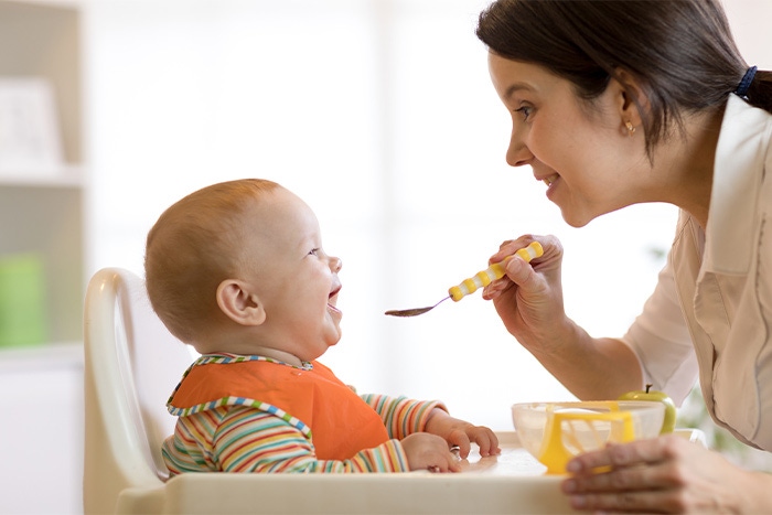 mother feeding the baby