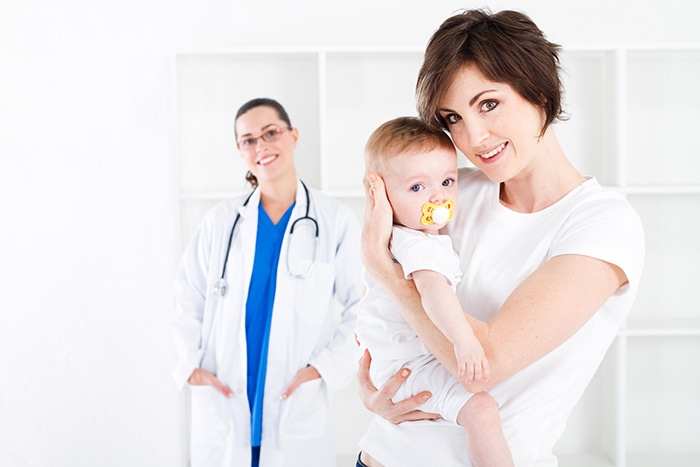 mom and baby on hand during a control visit to the pediatrician