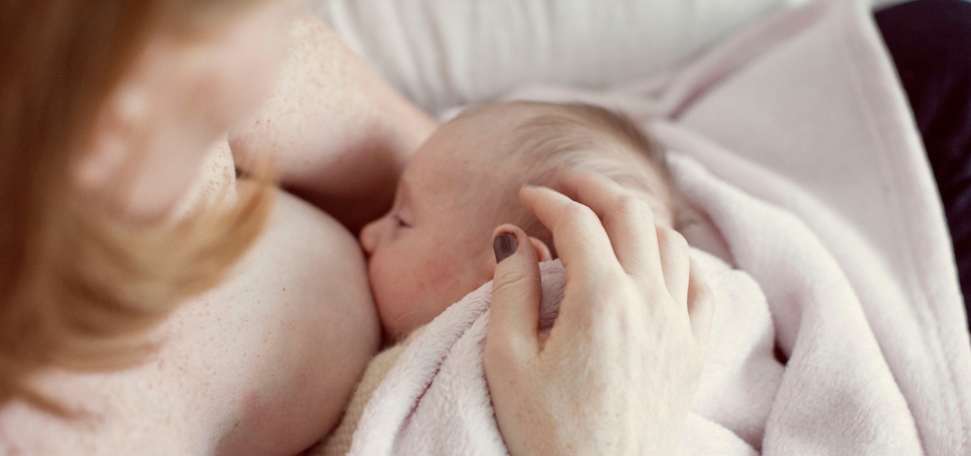 Mom breastfeeding newborn baby