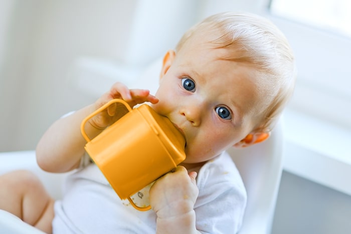 baby drinking milk with non-spill