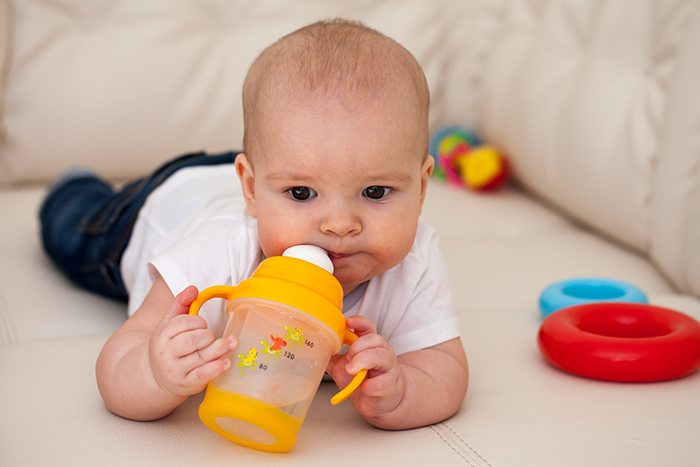 babies drinking from a cup