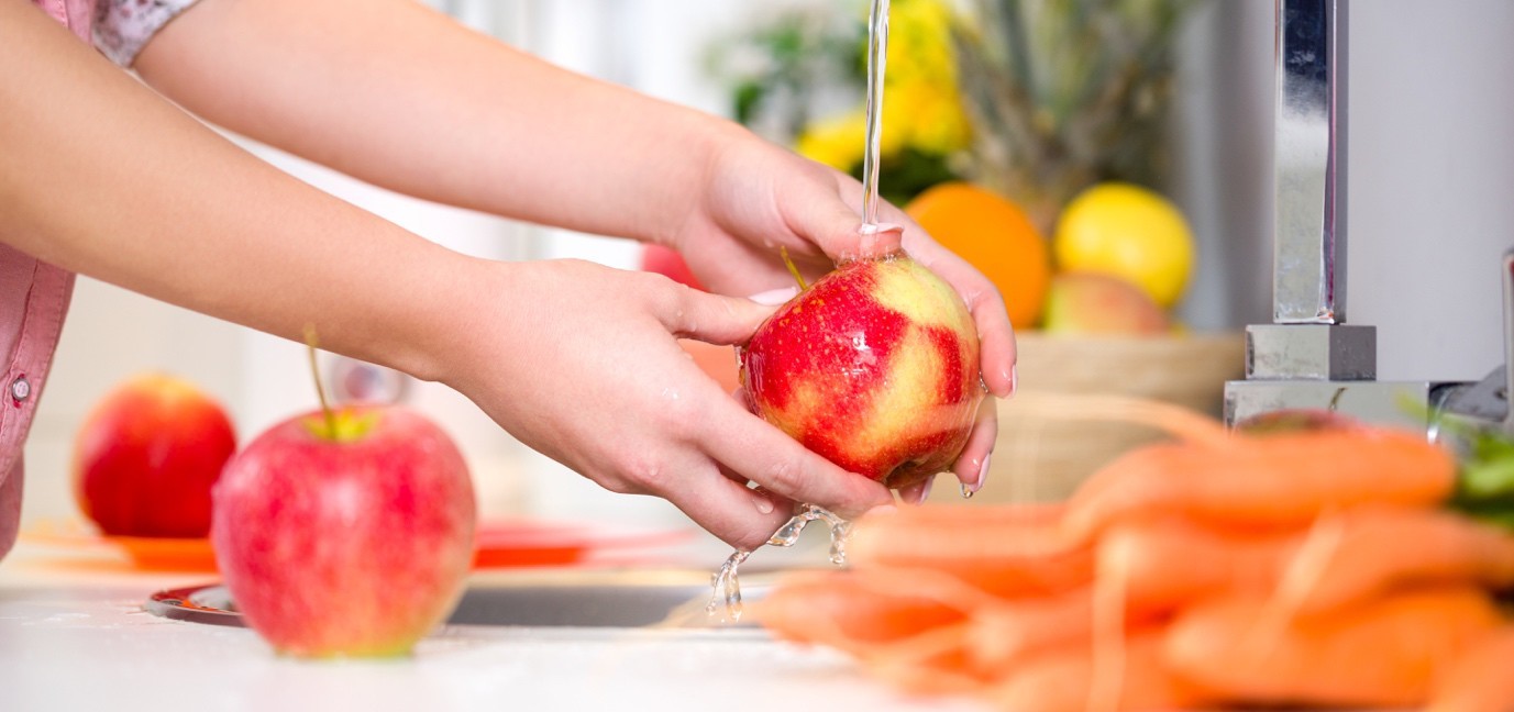 Pregnant woman washing apples