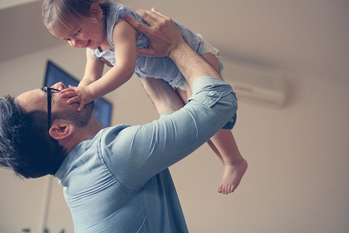 dad is playing with the baby