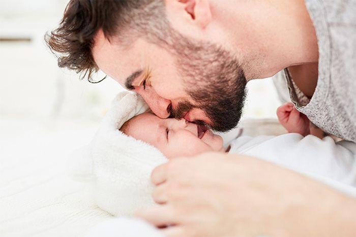 dad kisses the baby