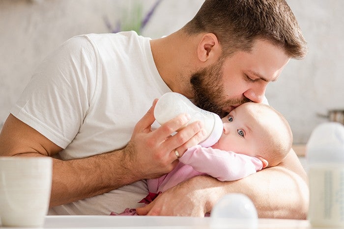 dad is feeding the baby