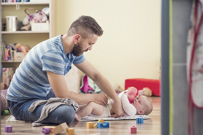 dad changing the baby