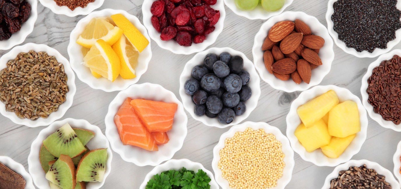 Different whole foods in white bowls