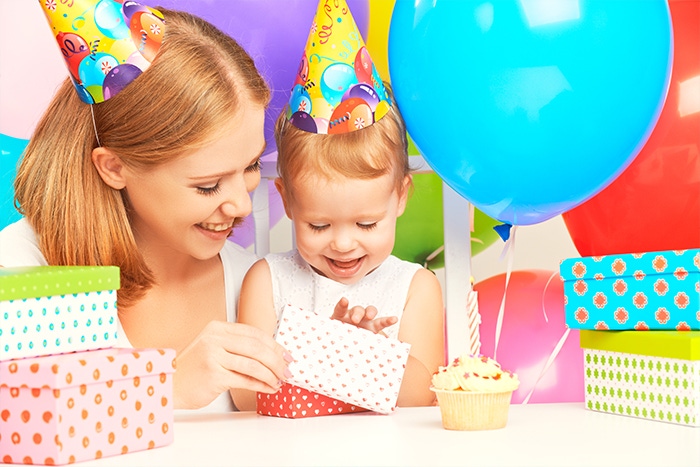 mom with baby open gifts