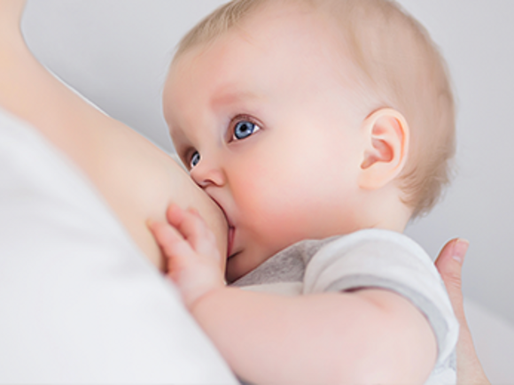 baby eats breast milk from mom's breast