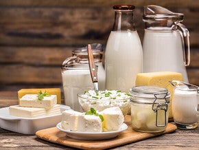 Assorted dairy products on a wooden table.