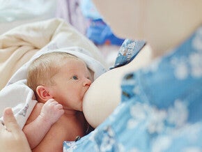 Mother breastfeeding a newborn baby.