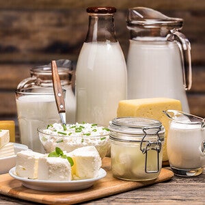 Assorted dairy products on a wooden table.
