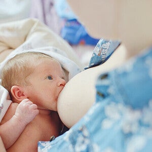 Mother breastfeeding a newborn baby.