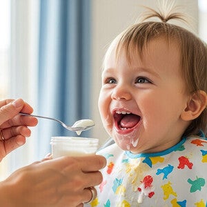 Dziewczynka jedząca deserek mleczny Nestlé Yogolino