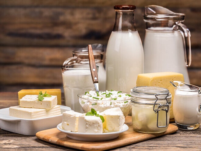 Assorted dairy products on a wooden table.