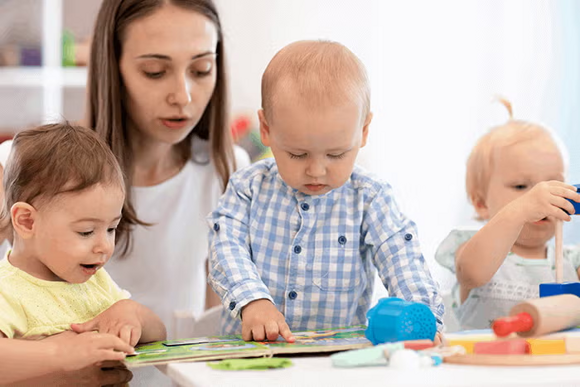 the children look at the book together with the teacher the children look at the book together with the teacher