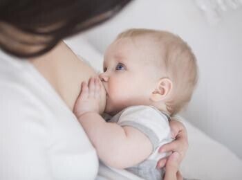 mother breastfeeds baby