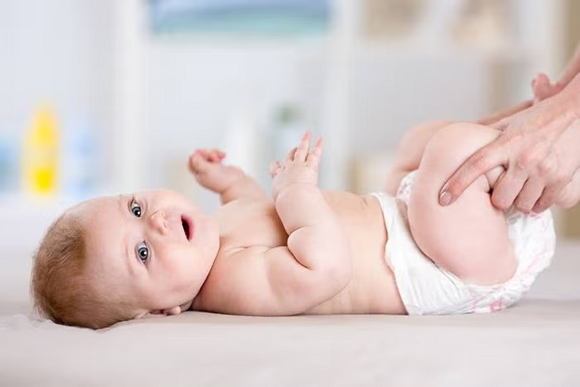 mama trzyma niemowlaka za nogi mama trzyma niemowlaka za nogi