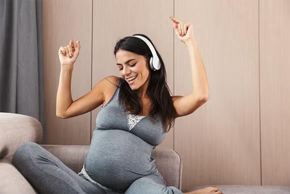 a pregnant woman listening to music a pregnant woman listening to music