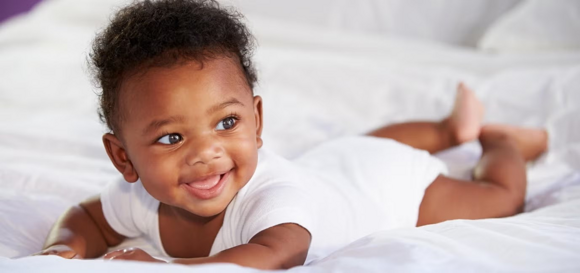 Baby smiling in bed Baby smiling in bed